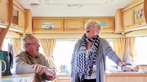 A couple showing the photographer are their campervan